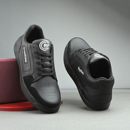Gray and black sneakers with visible branding on a gray background