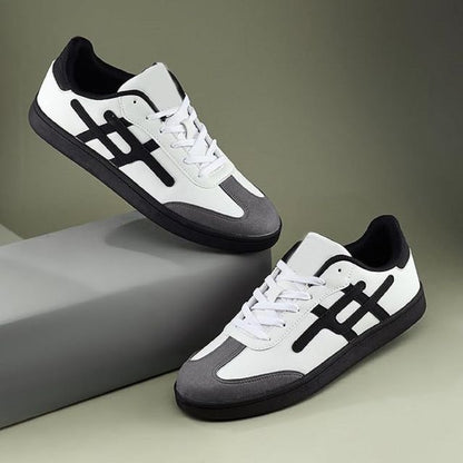 Pair of white and black sneakers on a gray and green gradient background
