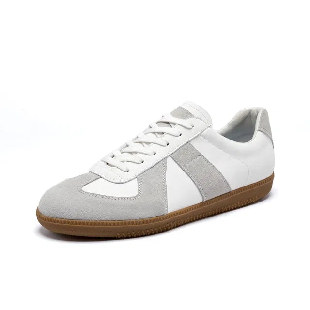White and gray sneaker with brown sole on a white background