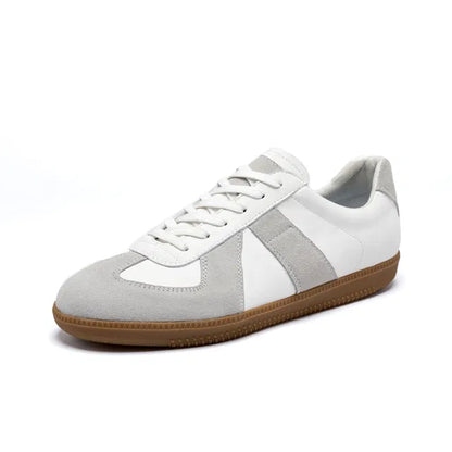 White and gray sneaker with brown sole on a white background