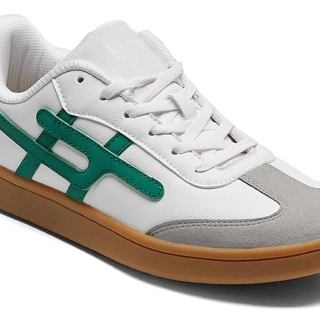 White and gray sneaker with green accents on a white background