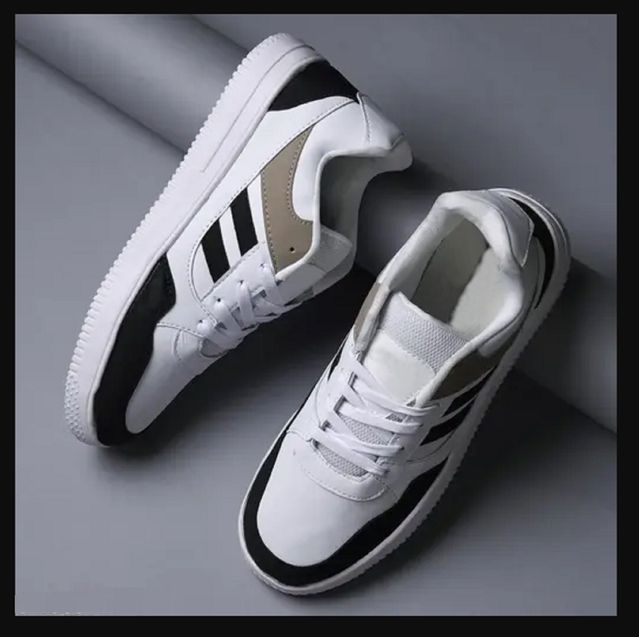 White sneakers with black accents on a gray background