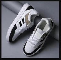 White sneakers with black accents on a gray background