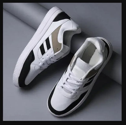 White sneakers with black accents on a gray background