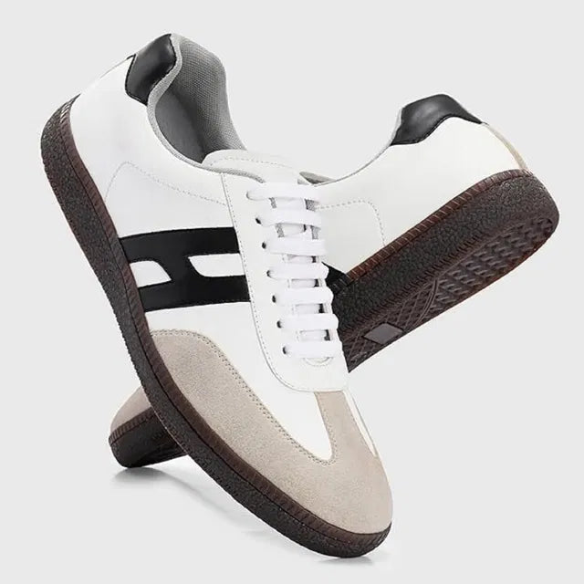 White sneakers with black accents on a light gray background