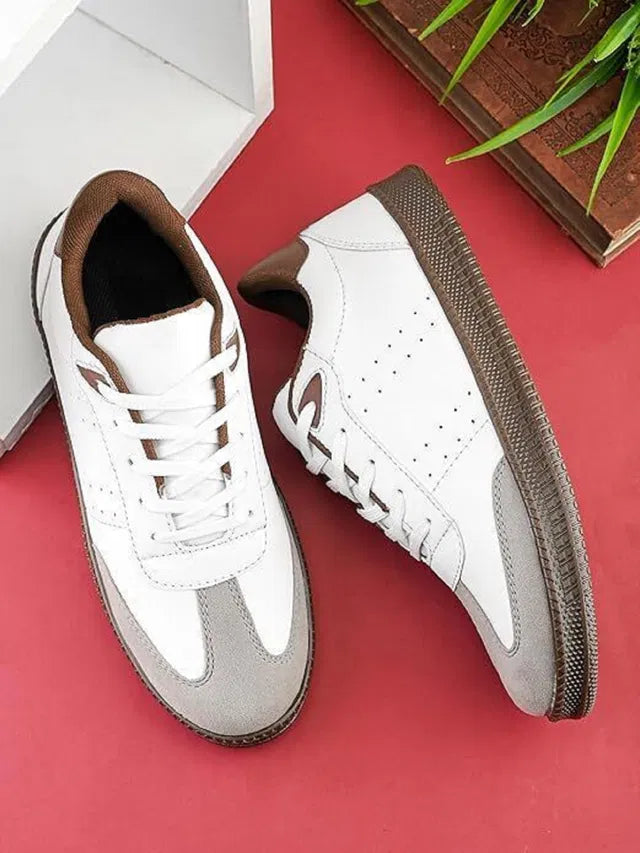 White sneakers with brown soles on a red surface