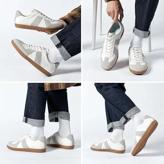 White sneakers with brown soles worn by a person on a white background