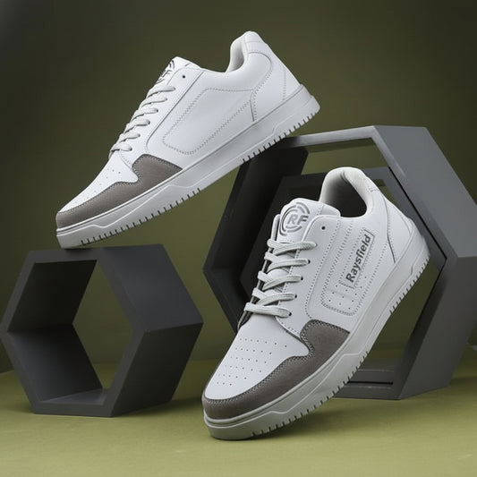 White sneakers with gray accents on a geometric black and green background
